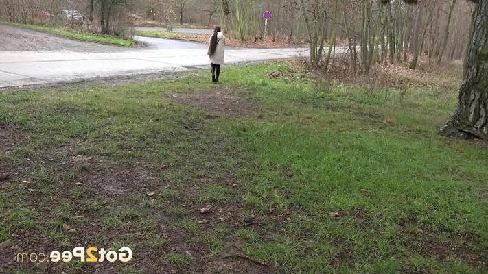 15P Brunette girl Lara Fox squats under a shelter to take a badly needed pee