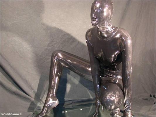 16P Solo model that is totally encased in latex has a dildo fitted into her mouth