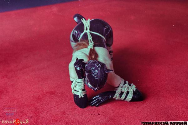 16P Pale redhead is left tied up while wearing latex clothing and a hood