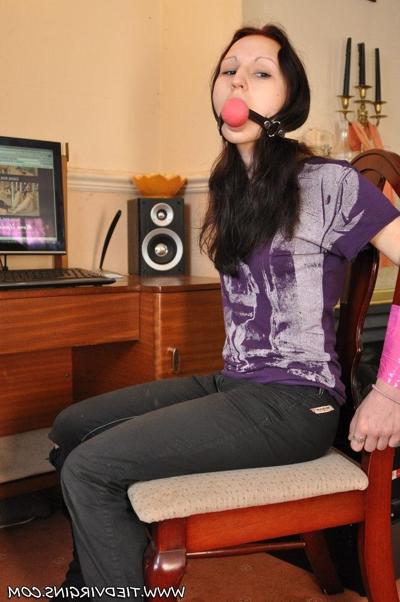 12P Caucasian girl is tied to a chair with a big ball gag in her mouth
