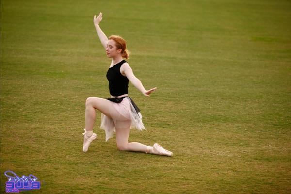 15P Natural redhead Nicki Blue works on her ballerina moves in an expansive field