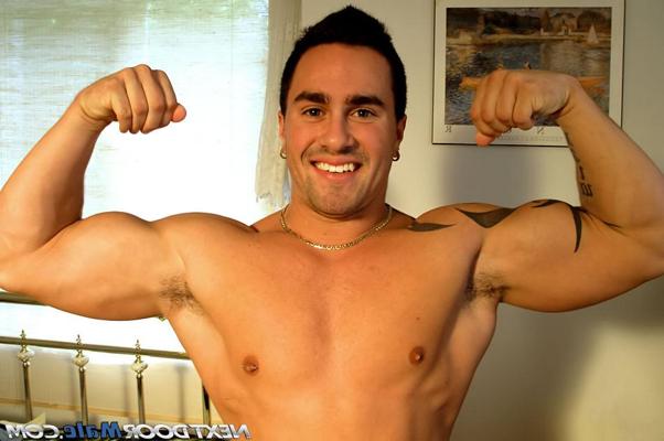 20P Amateur gay with a hot tattoo Mick C undresses and poses nude on a bed