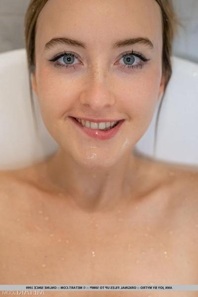 18P Blonde teen Ann Joy splashes water on her natural tits in a bathtub