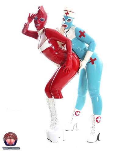 16P Lesbian women sport head to toe latex nurse clothing while grasping each other