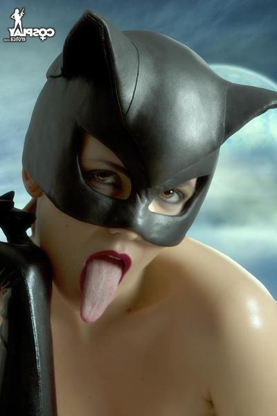 12P Solo model sticks out her long tongue while modelling fetish wear on a rooftop