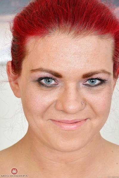 16P Older redhead model Corazon Del Angel removing fishnet stockings