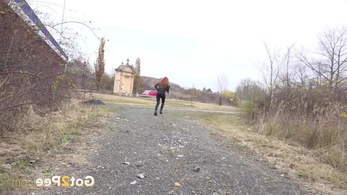 14P Natural redhead Katie Rose gets caught taking a piss upon a gravel road