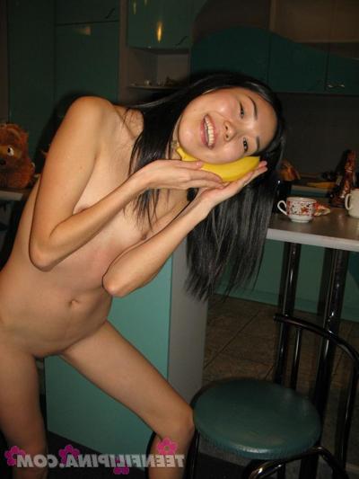 15P Skinny Filipina teen Nicoline Yiki fools around with a banana while bare naked