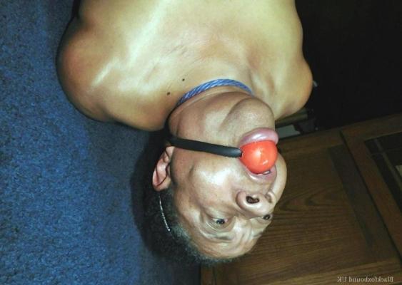 16P Overweight black woman Trixie struggles against a ball gag while hogtied