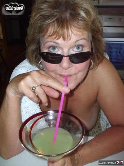 20P Mature woman Busty Bliss exposes her boobs while enjoying an alcoholic drink