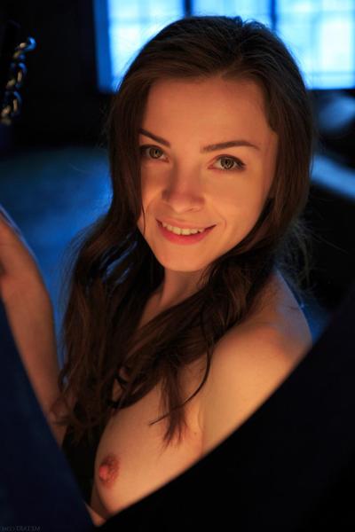 18P British girl Una Piccola spends winter evening playing her guitar in cozy room