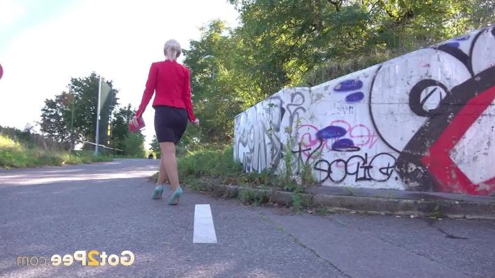 15P Blonde girl Di Devi takes a piss in front of a graffiti strewn wall