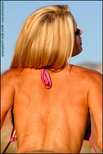 15P Hot blonde bodybuilder Christy Allen undoes the strings of her bikini outdoors