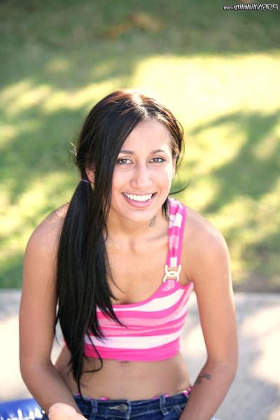 18P Petite brunette teen Amia Miley enjoys some outdoor play time on a trampoline