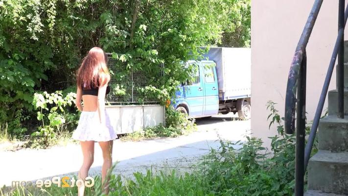 15P Skinny female Cynthia Vellons takes a piss on public steps in a miniskirt