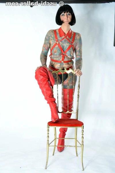 16P Solo girl Tattoogirl Cleo models a bondage harness in thigh-high boots