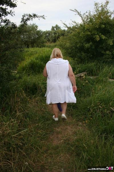 16P Fat British lady Lexie Cummings exposes herself on a bench in a field