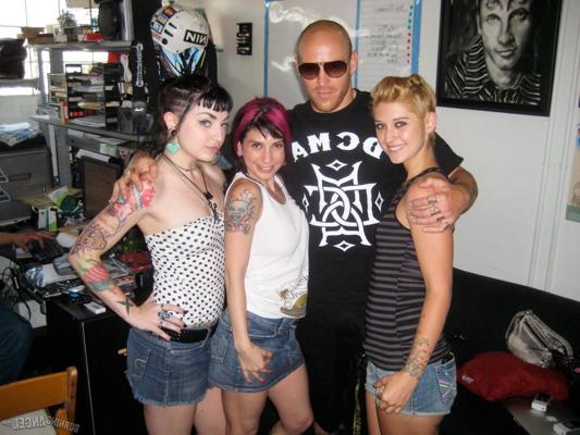 15P Clothed females with tattoos flash their butts while at a party