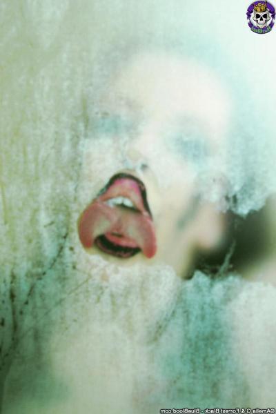 15P Goth girl Penny Poison presses up against a steamy shower stall in the nude