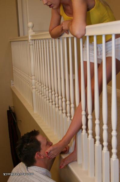 12P Fully clothed blonde has her feet worshipped while leaning over a railing