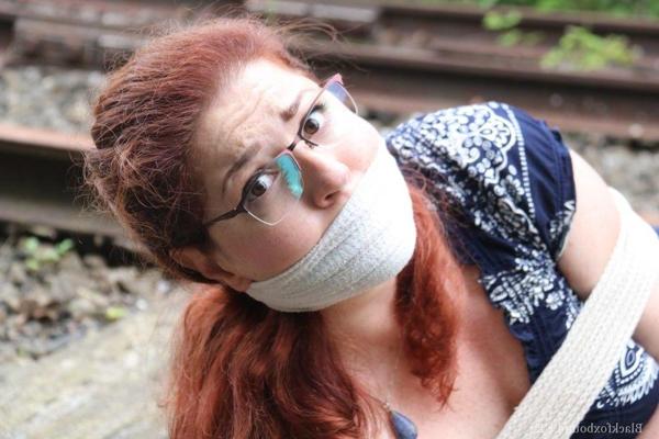 16P Fully clothed redhead is left gagged and bound on railway tracks
