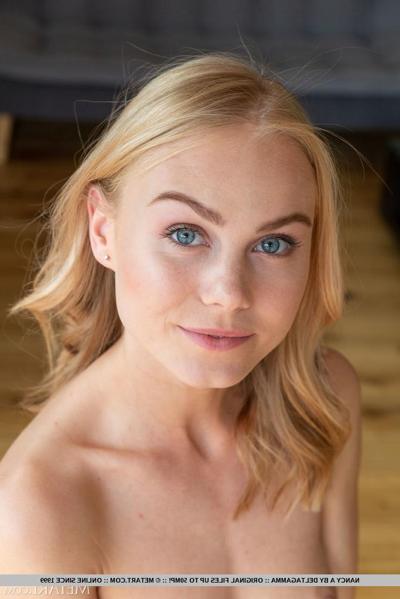 18P Beautiful blonde teen Nancy A discards a bodysuit to model in the nude