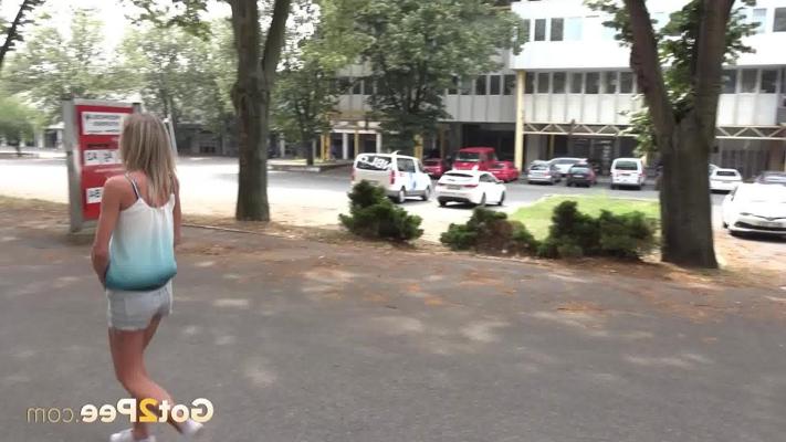 15P Blonde chick Claudia Macc leans against a post while peeing in public