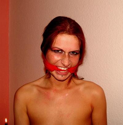 14P Restrained redhead struggles against her bindings while blindfolded and gagged