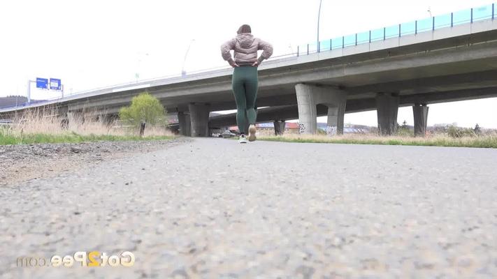 15P Caucasian girl Barbe takes a pee on a paved road during the day
