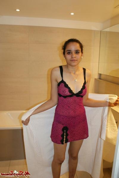 12P Pretty Indian girl lets a tit loose of her lingerie while in a bathroom