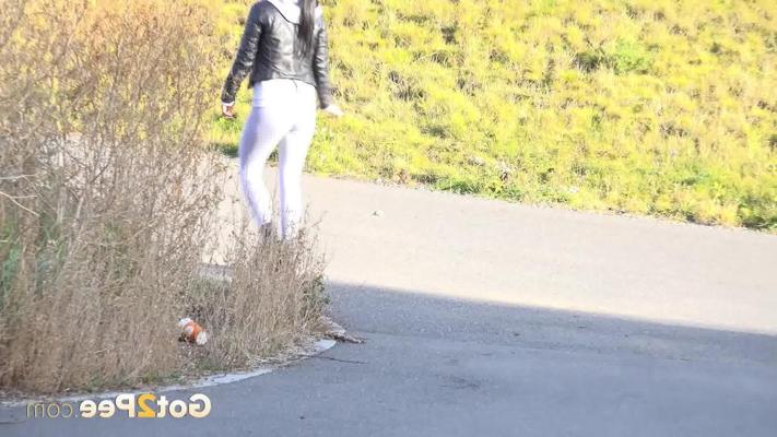 15P Solo girl Dafne pees on a driveway while wearing shades and boots