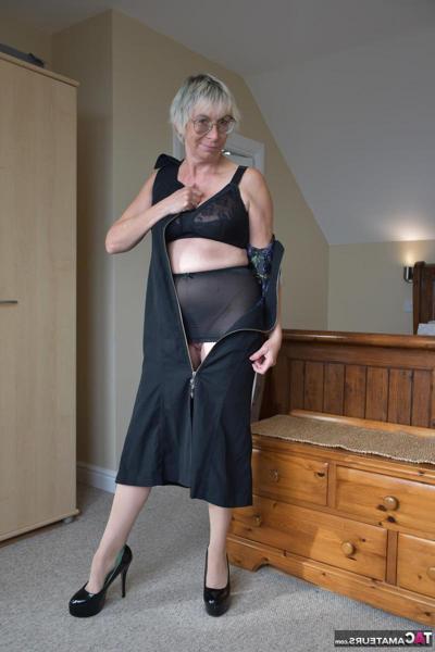 16P Naked British woman Barby Slut gets dressed on a trunk in her bedroom