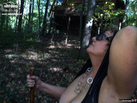 15P Mature woman Busty Bliss shows her natural tits outside her rural dwelling