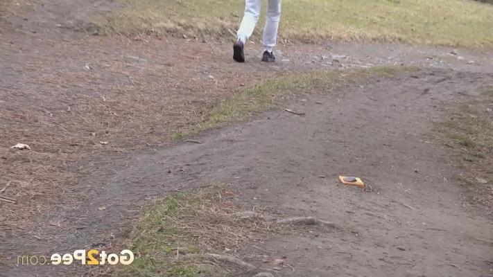 15P Ali Bordeaux takes a pee beside a walking path while wearing a winter coat