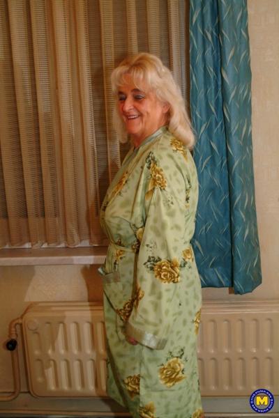 20P Mature Dutch housewife Henrietta posing in her top, stockings and short skirt