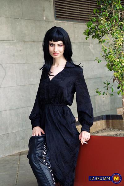 18P Raven-haired woman poses in her sexy black outfit and boots in public