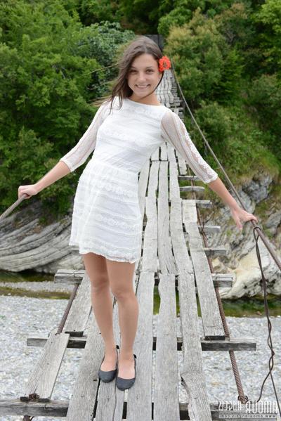 20P Petite teen wears a flower in her hair while posing nude on suspension bridge