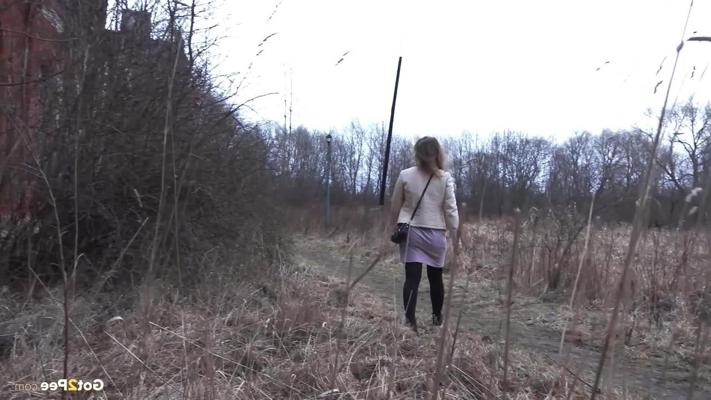 15P Short taken girl Rita squats for a piss behind a building in the countryside