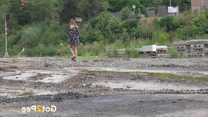 15P Yenna takes a piss in a puddle while wearing flip-flops