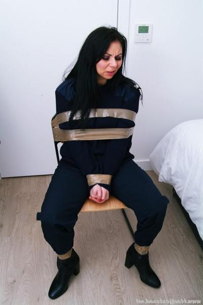 16P Dark-haired police woman finds herself taped to a chair in her uniform