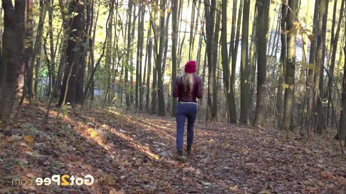 15P Blonde girl Caroli pulls down her jeans to pee on leaves in the woods