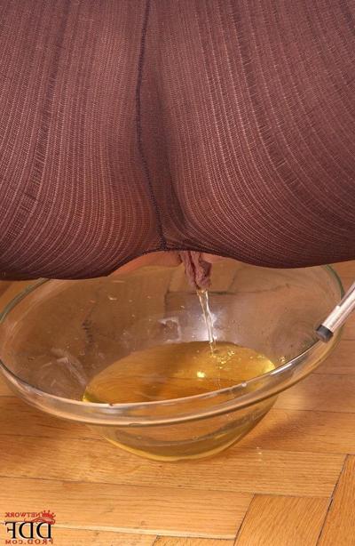16P Hot chick Sandy pisses into a glass dish wearing a crotchless bodystocking