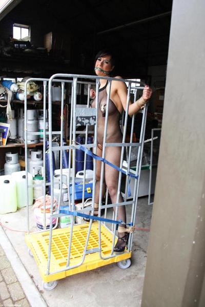 16P Restrained brunette in a crotchless bodystocking has her nipples clamped