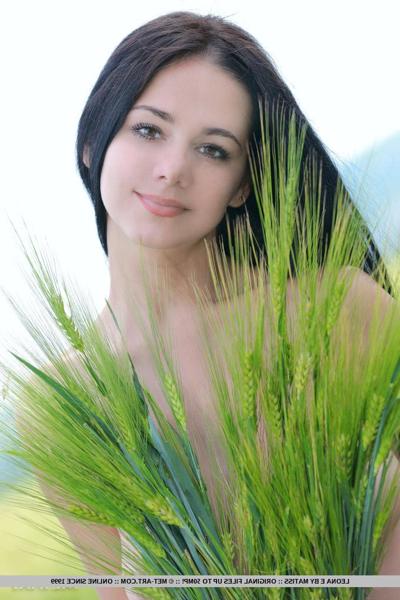 18P Pretty brunette teen Leona E unveiling big natural tits outdoors in field