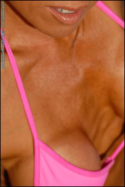 15P Asian fitness model Jennifer Dejoya poses in a pink bikini upon a beach