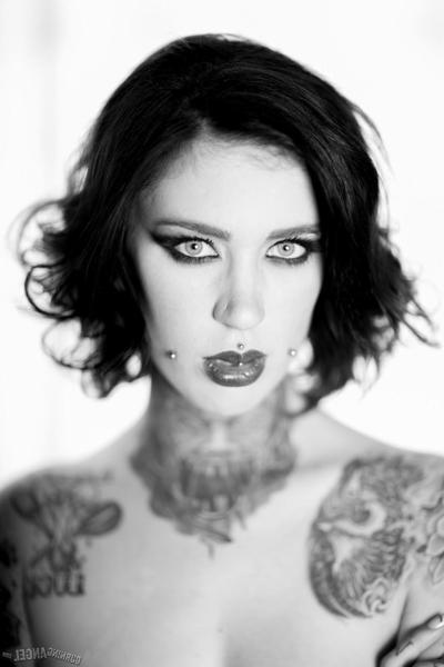 17P Brunette whore shows off her naked tattooed body in a hot black and white solo