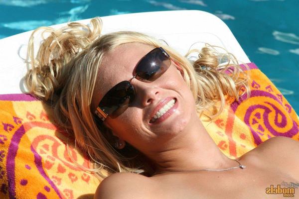 16P Blonde chick shows her bald pussy while smoking during nude sunbathing