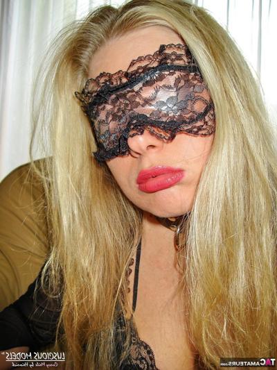 16P Blonde amateur cups her breasts before donning a mask in black lingerie