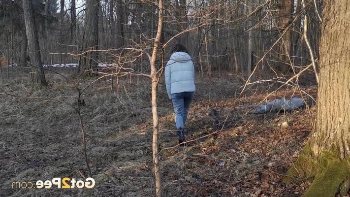 15P Caucasian girl Nikky B leans back against a tree while taking a piss
