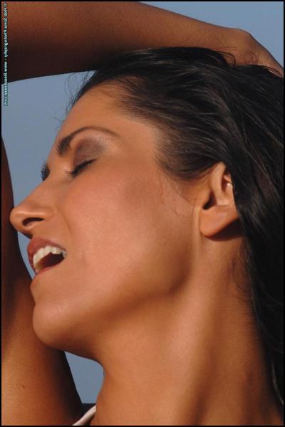 15P Brunette MILF Catrina Owens works her great tits free of a bikini at the ocean